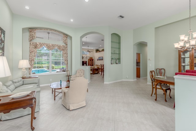 living room featuring ceiling fan with notable chandelier