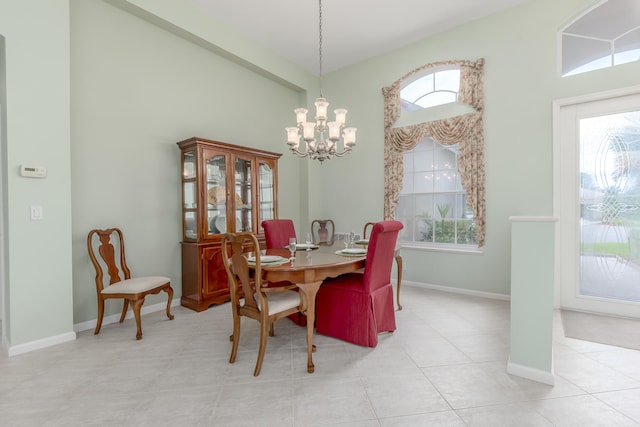 dining space with a chandelier and light tile patterned floors