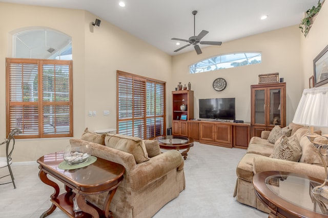 tiled living room with high vaulted ceiling and ceiling fan