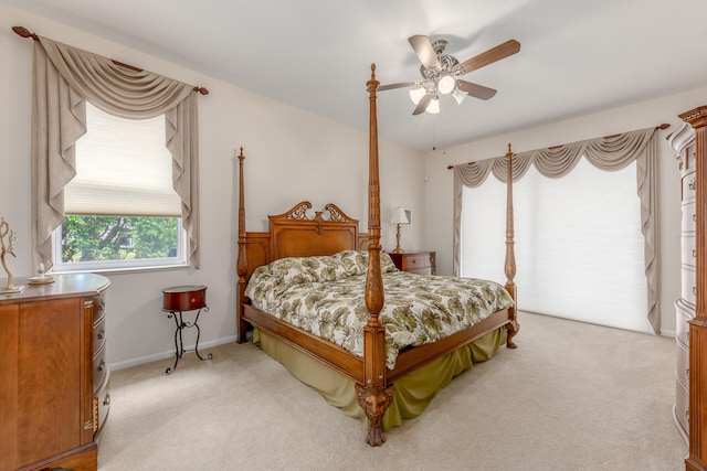 bedroom featuring light carpet and ceiling fan