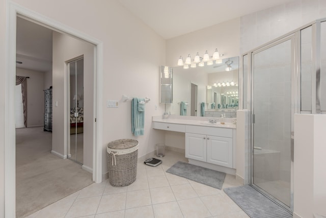 bathroom featuring vanity, a shower with shower door, and tile patterned flooring