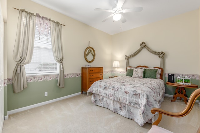 bedroom with light colored carpet and ceiling fan