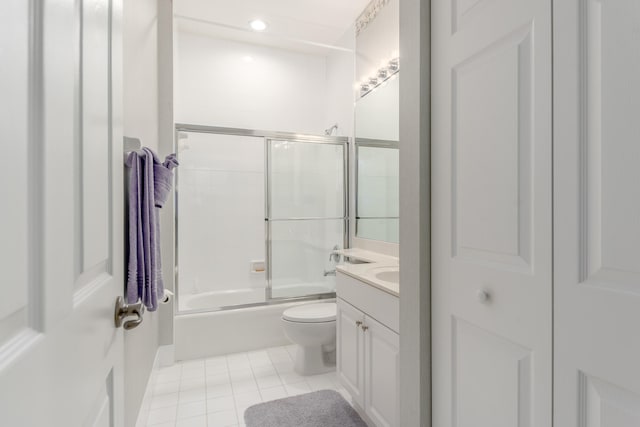 full bathroom with combined bath / shower with glass door, tile patterned flooring, toilet, and vanity