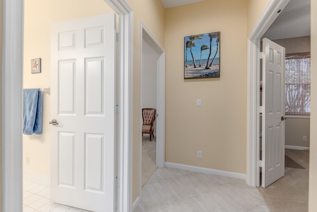 hall featuring light tile patterned floors