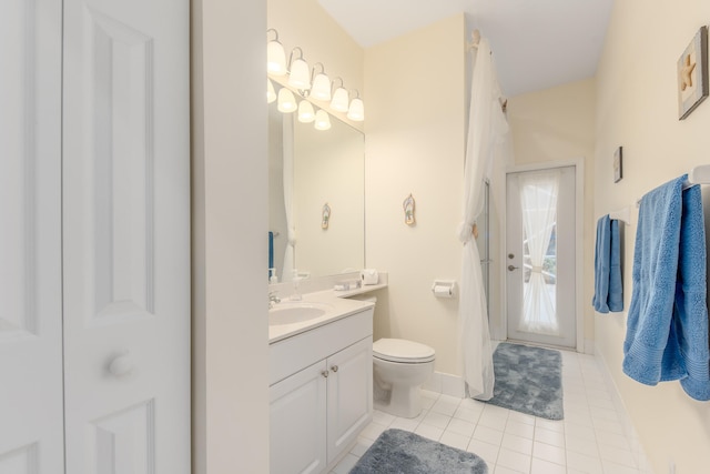 bathroom featuring toilet, vanity, and tile patterned floors