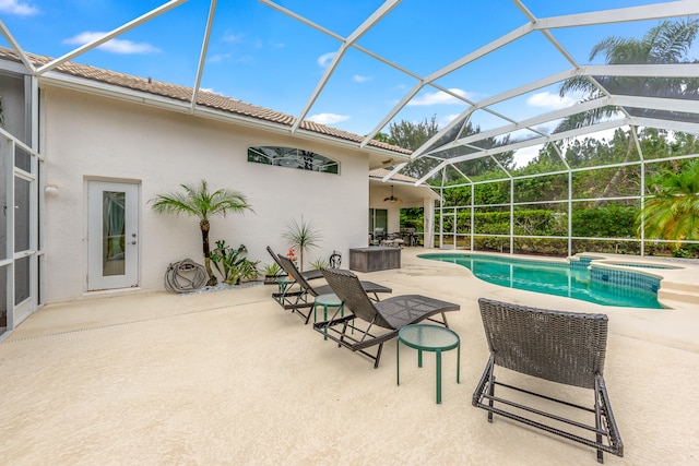 view of pool with a lanai, ceiling fan, and a patio area