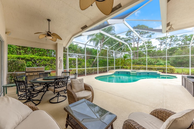 view of swimming pool with ceiling fan, area for grilling, a lanai, and a patio area