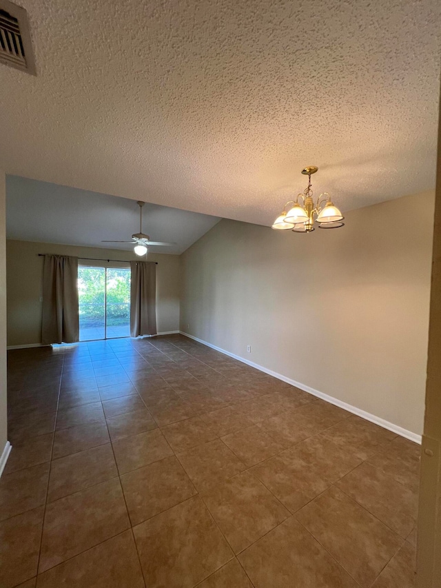 unfurnished room featuring dark tile patterned floors, a textured ceiling, and ceiling fan with notable chandelier