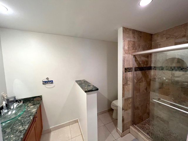 bathroom with walk in shower, tile patterned flooring, vanity, and toilet