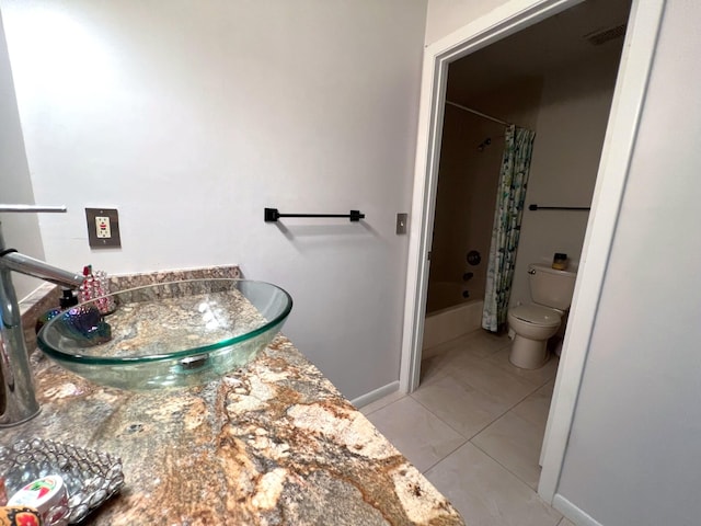 full bathroom featuring vanity, tile patterned floors, toilet, and shower / tub combo with curtain