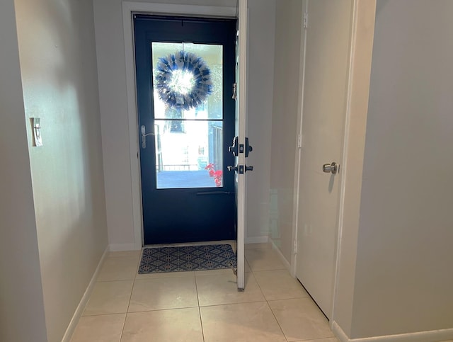 doorway to outside featuring light tile patterned flooring