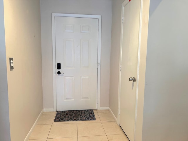 doorway with light tile patterned flooring