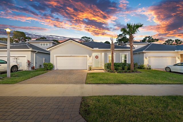 view of front of home featuring a lawn and a garage