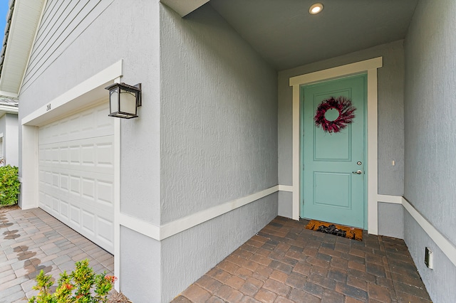 doorway to property with a garage