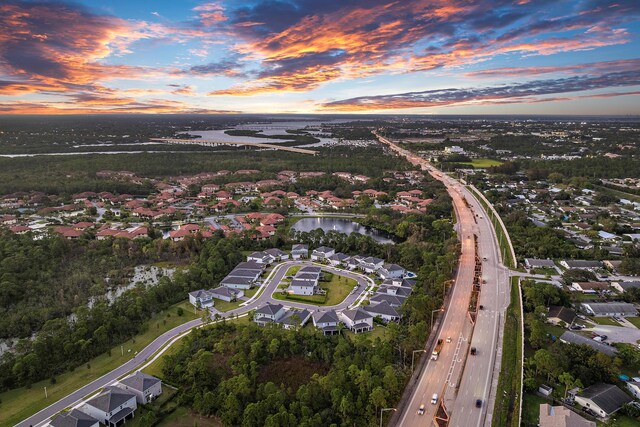200 SW Pomeroy St, Stuart, FL 34997 - aerial overview of property's location with a main thoroughfare, a large body of water, and nearby suburban area