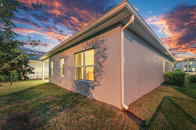 200 SW Pomeroy St, Stuart, FL 34997 - property exterior at dusk featuring stucco siding