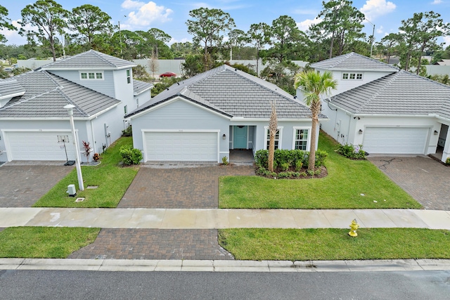 200 SW Pomeroy St, Stuart, FL 34997 - view of front of home featuring a tile roof, stucco siding, and a front lawn