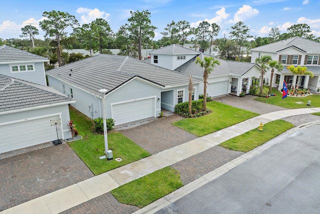 front facade featuring a garage and a front yard