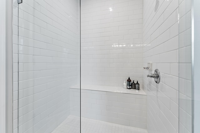 bathroom with a tile shower