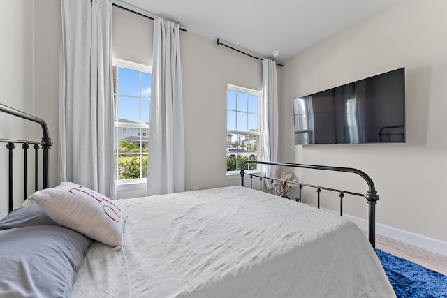 bedroom with hardwood / wood-style flooring