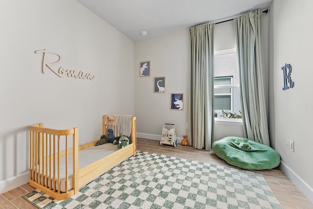 200 SW Pomeroy St, Stuart, FL 34997 - bedroom featuring wood tiled floors and baseboards