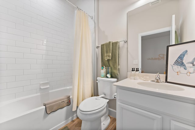 full bathroom with hardwood / wood-style flooring, vanity, toilet, and shower / tub combo