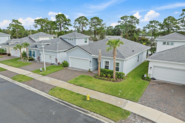 200 SW Pomeroy St, Stuart, FL 34997 - traditional-style house featuring driveway, a tiled roof, a front yard, stucco siding, and an attached garage