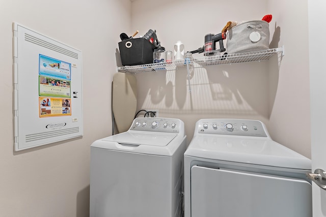 clothes washing area featuring separate washer and dryer