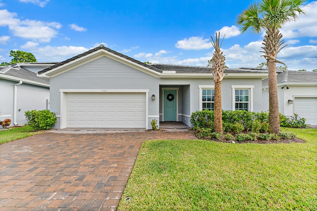 ranch-style house featuring a garage and a front lawn