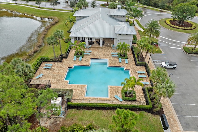 view of swimming pool with a water view and a patio area