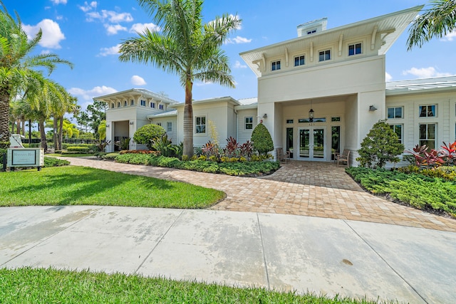 view of front of property with french doors and a front yard