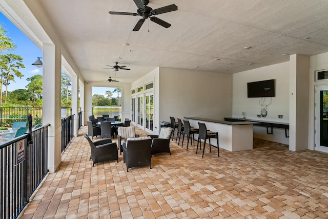 view of patio with outdoor lounge area, an outdoor bar, and ceiling fan