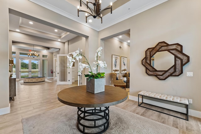 200 SW Pomeroy St, Stuart, FL 34997 - foyer entrance with a chandelier, crown molding, baseboards, light wood-style floors, and recessed lighting