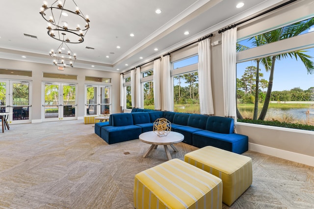 sunroom / solarium featuring a water view, french doors, a notable chandelier, and a healthy amount of sunlight