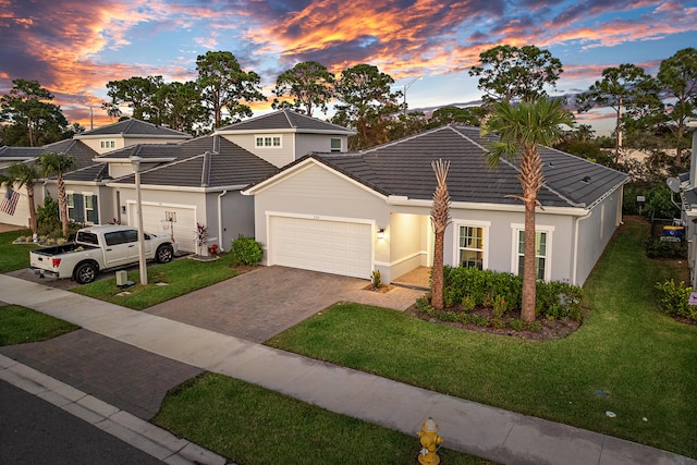 view of front of home featuring a garage and a yard