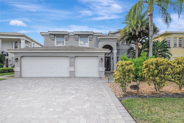 mediterranean / spanish-style house with a garage