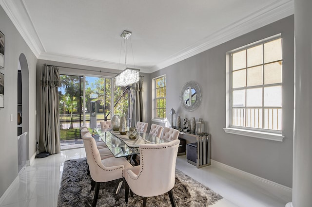 dining area with plenty of natural light and crown molding