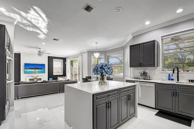 kitchen with a center island, light tile patterned floors, sink, stainless steel dishwasher, and crown molding