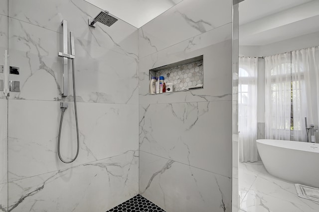 bathroom featuring shower with separate bathtub