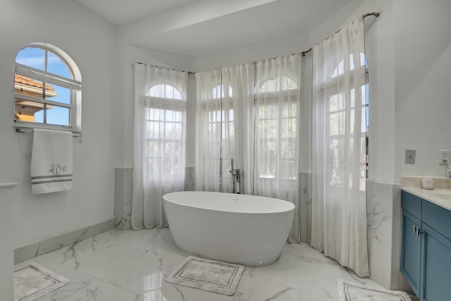 bathroom with a washtub and vanity