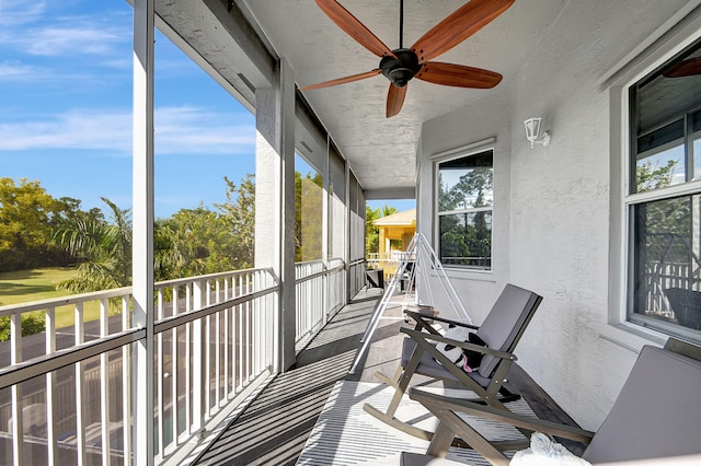 sunroom / solarium featuring ceiling fan