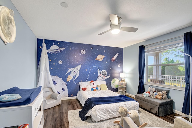 bedroom featuring a textured ceiling, dark hardwood / wood-style flooring, and ceiling fan