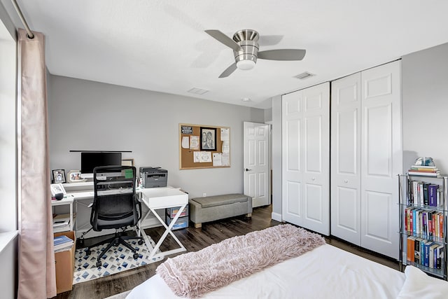 bedroom with ceiling fan, dark hardwood / wood-style floors, and a closet