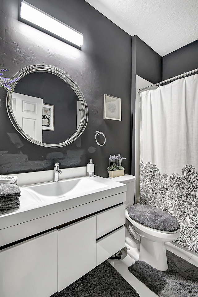 bathroom with vanity, tile patterned floors, and toilet