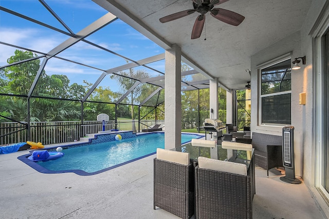 view of swimming pool with a lanai, grilling area, ceiling fan, and a patio