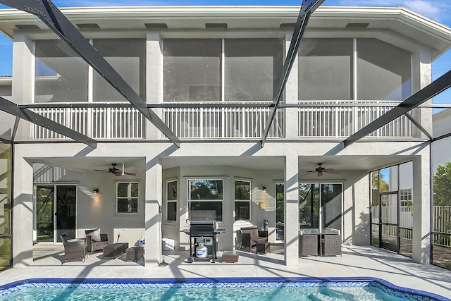 rear view of house featuring ceiling fan, a patio, and a balcony