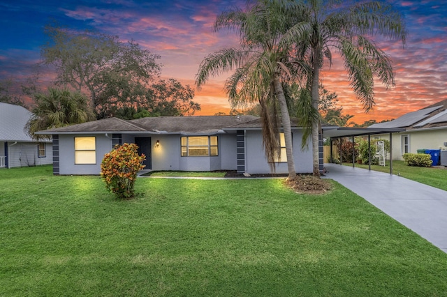 view of front of property featuring a lawn and a carport