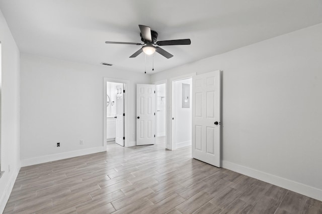 unfurnished bedroom with light hardwood / wood-style floors, ceiling fan, and connected bathroom