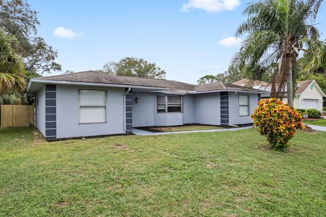 ranch-style house with a garage and a front yard