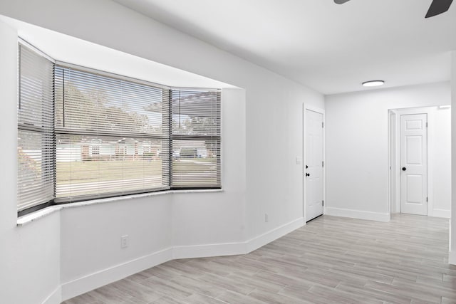 unfurnished room with light hardwood / wood-style floors and ceiling fan